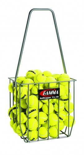 A wire tennis ball hopper filled with bright yellow tennis balls. Ideal for organizing and transporting balls during practice sessions.