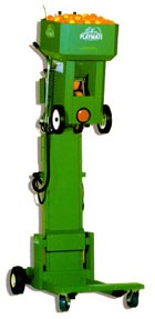 Green automated citrus harvester designed for efficient fruit collection. It features a tall frame with a fruit hopper on top, suitable for orchards.