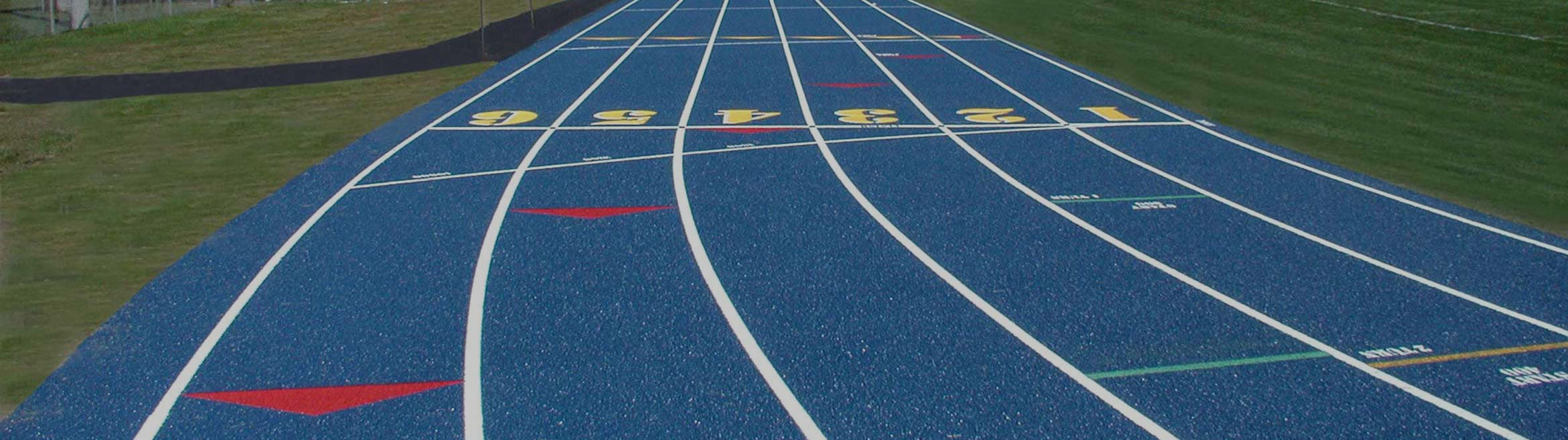 Blue synthetic running track with numbered lanes and directional arrows, designed for athletic training and competitions.