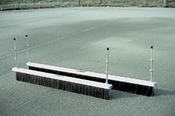 Tennis court drying equipment with brushes for sweeping and leveling the surface, ensuring optimal playing conditions after rain.